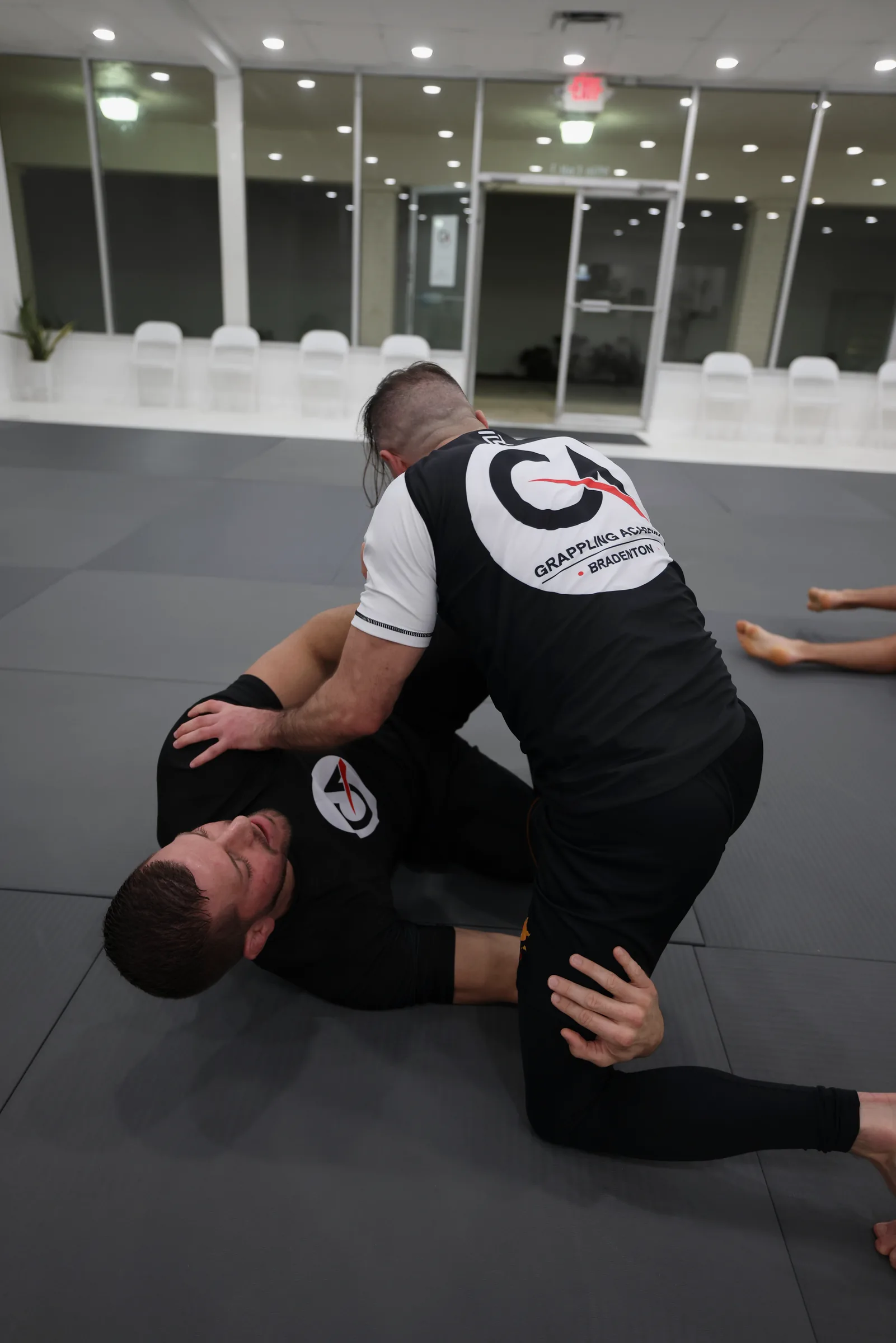 Practitioners shaking hands on the mat